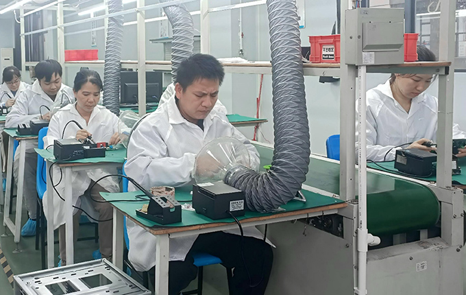 Workers assemble EV chargers